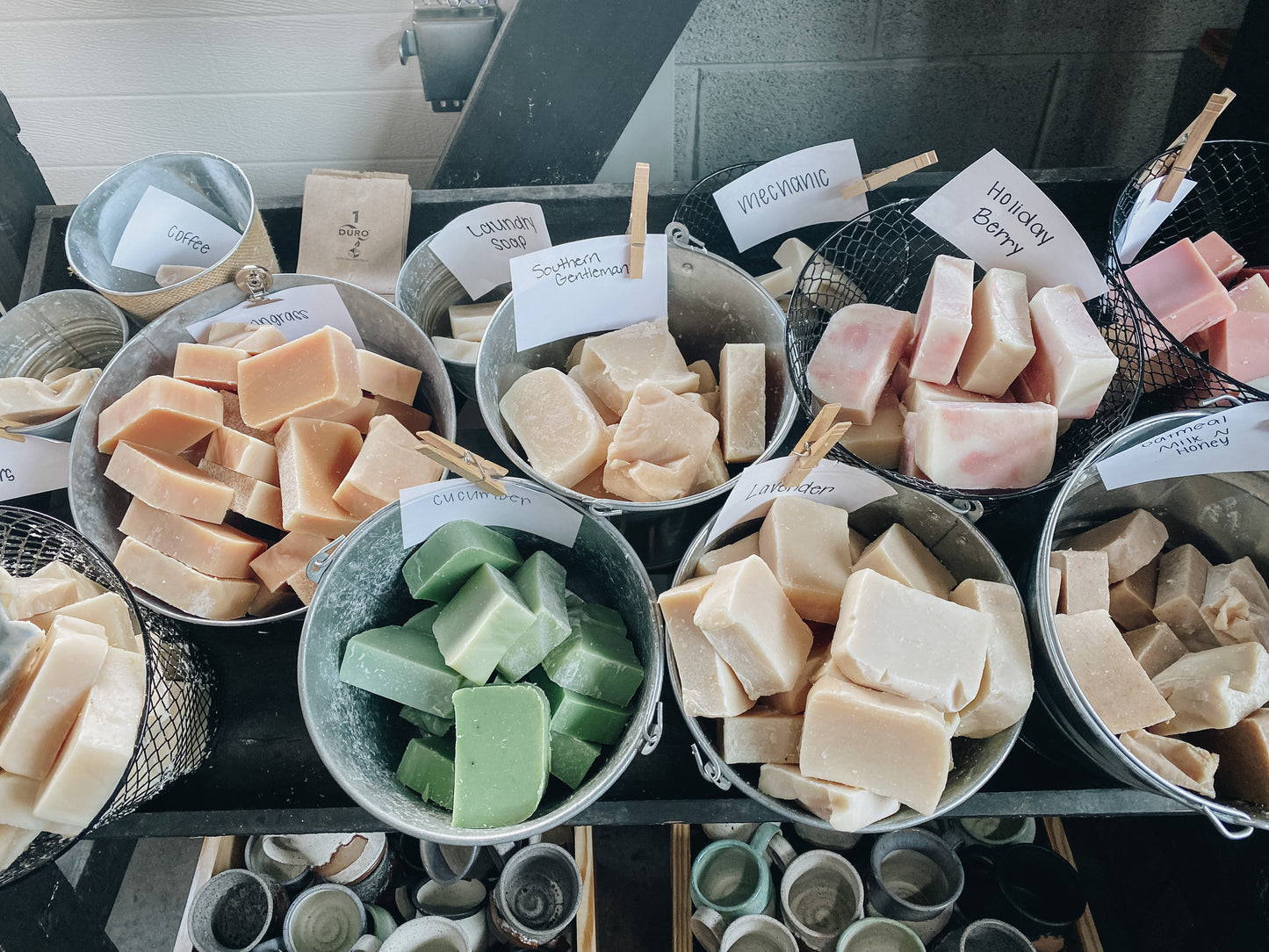 buckets full of unwrapped goat milk soap displayed in our retail soap shop