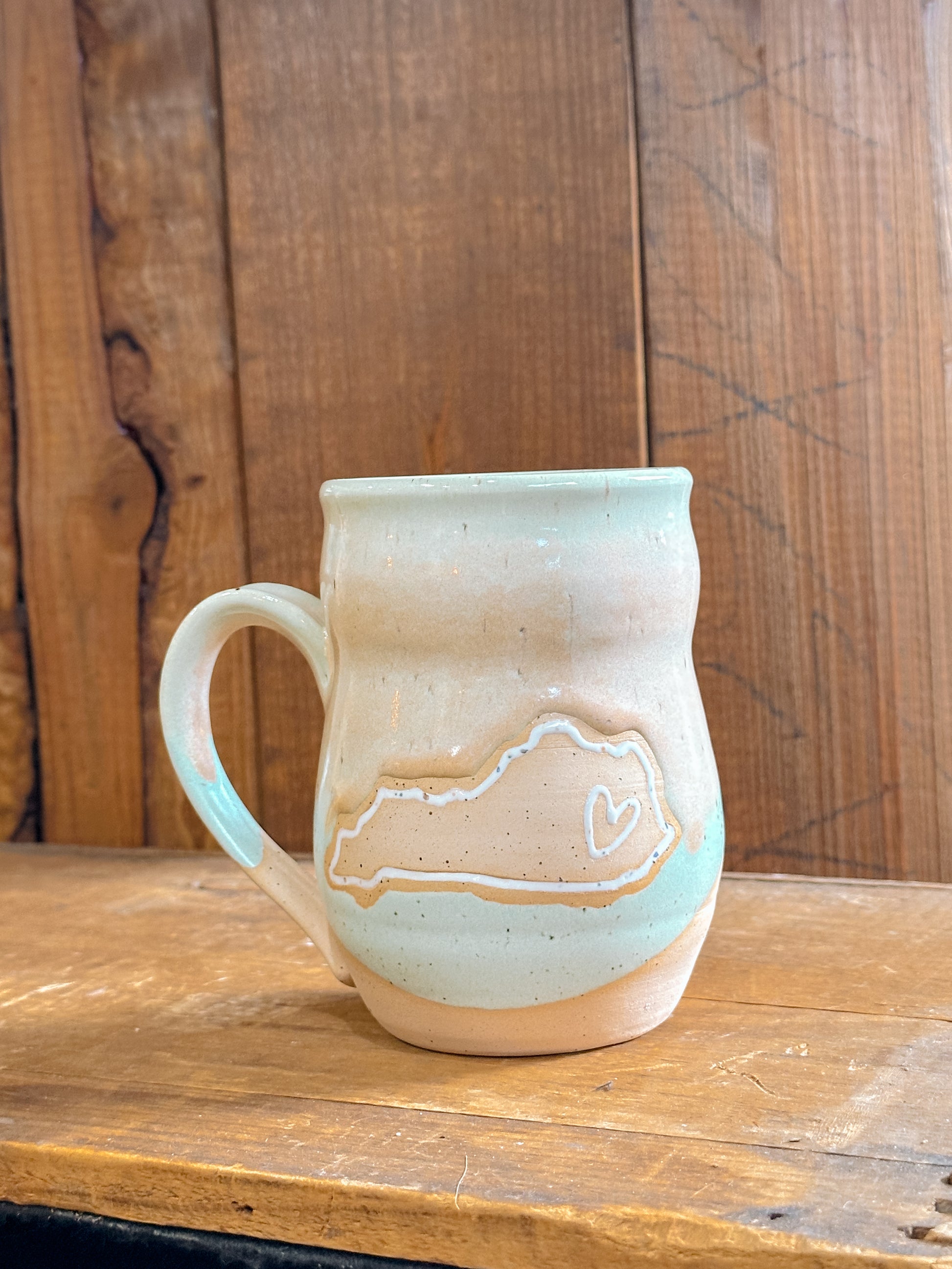 Variety of handmade Slab & Cedar mugs with Kentucky mountains etched on the side – ceramic drinkware with heart on Kentucky .