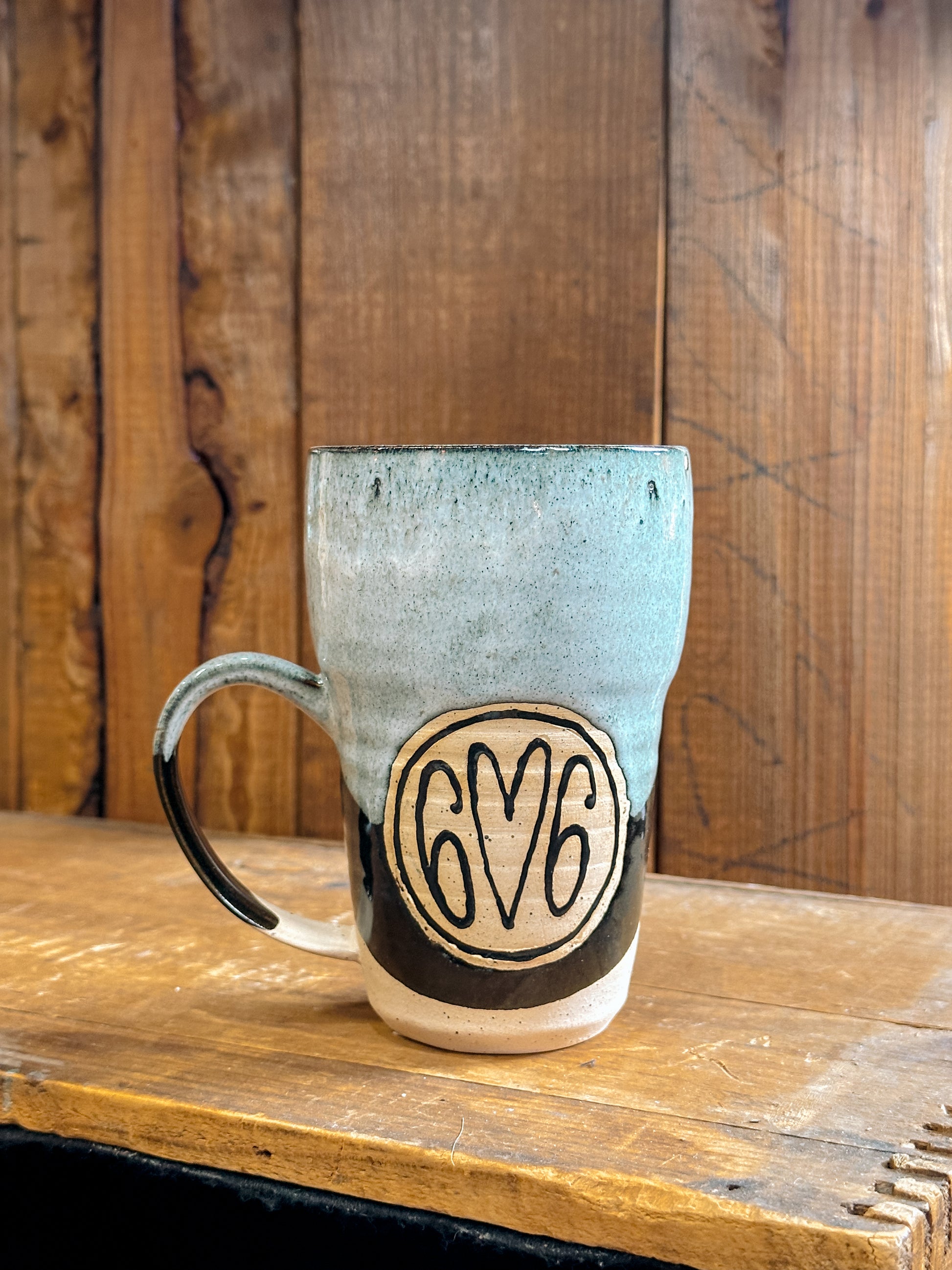 Variety of handmade Slab & Cedar mugs with Kentucky mountains etched on the side – ceramic drinkware with 606.