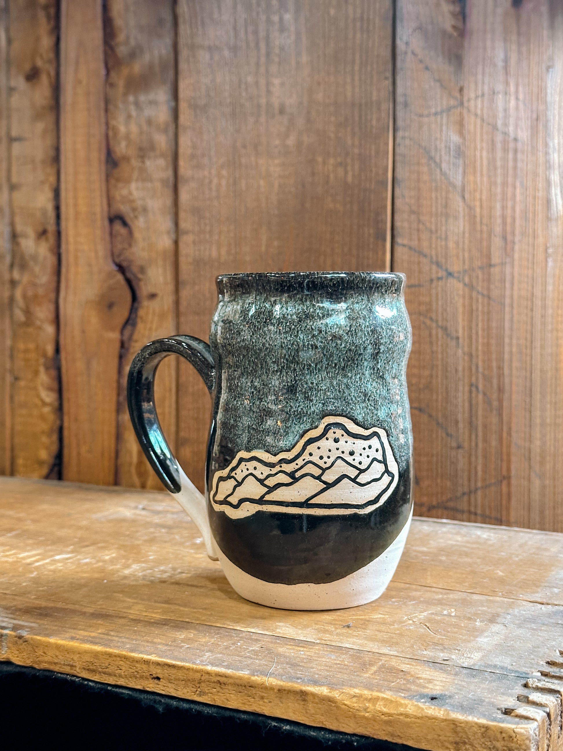 Variety of handmade Slab & Cedar mugs with Kentucky mountains etched on the side – ceramic drinkware inspired by Appalachian landscapes black. 